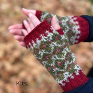 Women's hand in a pair of fingerless mittens