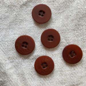 Brown buttons on a linen background