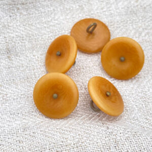 Five ochre buttons with a bronze metal shank