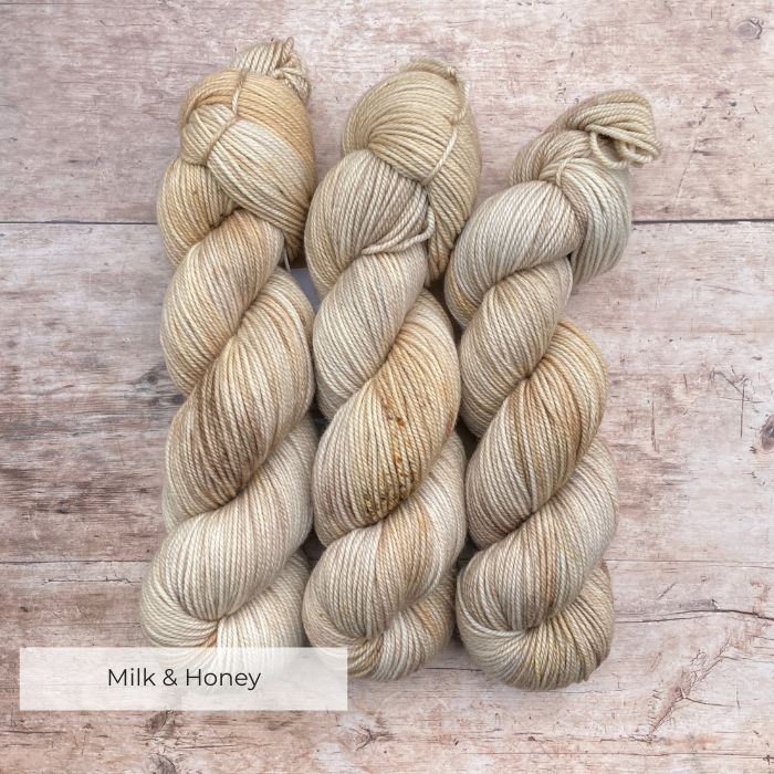 Three skeins Plump Sock Yarn in shades of cream and buff
