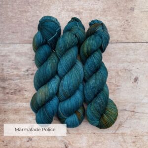Three Skeins of Plump Sock Yarn in shades of blue, teal and gold