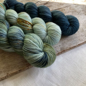 Three plump skeins in shades of green