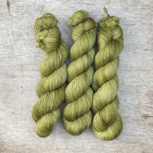 Three silky skeins in a soft green
