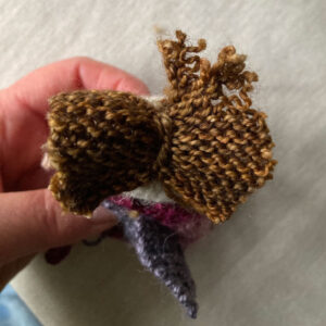 square of knitting sewn on to the top of the fairy head
