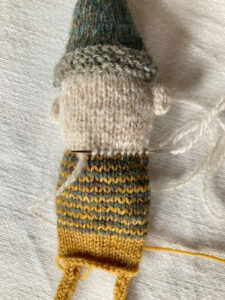 running stitch at the base of a gnomes head