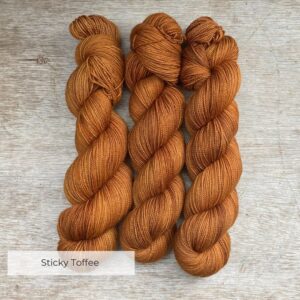 Three skeins of golden toffee coloured yarn