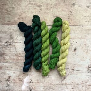 Five mini skeins of Classic sock wool in shades of green