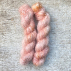 Two skeins of fluffy mohair in pale coral pink