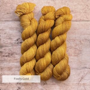 Three skeins of Merino & Silk wool in a rich golden mustard