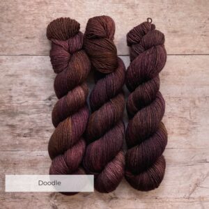 three skeins of Merino & Silk wool in brown, dusty pink and bronze