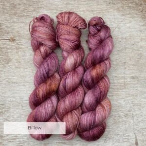 Three skeins of merino mohair yarn in pinks and golds
