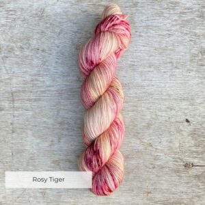 Creamy yellow yarn heaven speckled with dark red and pinks