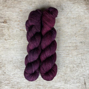 Two skeins of silky yarn in rich berry colours