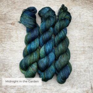 Three skeins of softly silky yarn in shades of dark blue, green and teal