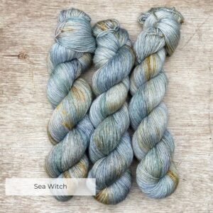 Three skeins of a pale blue green with splashes of yellow