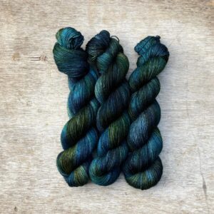 Three skeins of Mohair Sock wool in dark blues, emeralds and lime