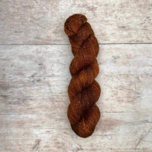 skeins of merino and linen in a rich rust
