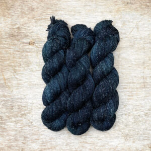 Three skeins of merino and linen in darkest blue black