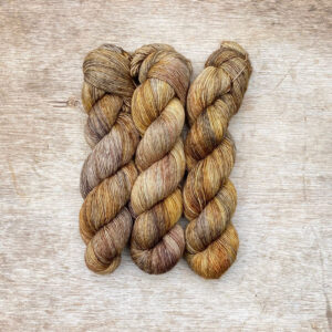 Three skeins of merino and linen in cafe au lait, gold and grey