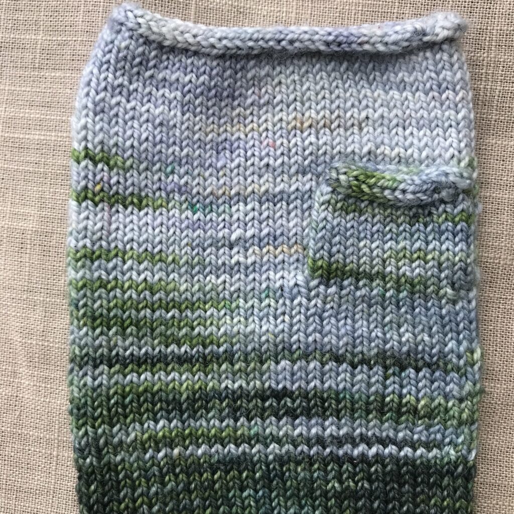 Back of Water Lily mitten showing thumb and cord edges