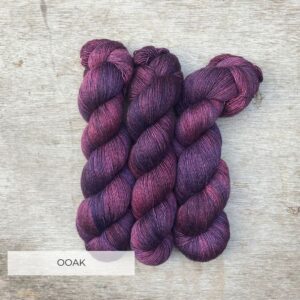 Three skeins of Merino & Silk in purple and plum