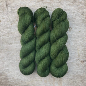 Three skeins of Classic Sock in cub scout green
