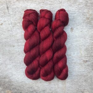 Three skeins of Merino Floof in a deep blood red