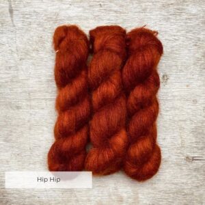 Three skeins of burnt orange mohair and silk lace