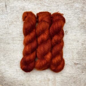 Three skeins of burnt orange mohair and silk lace