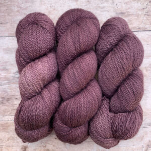 Three skeins of mauve DK wool
