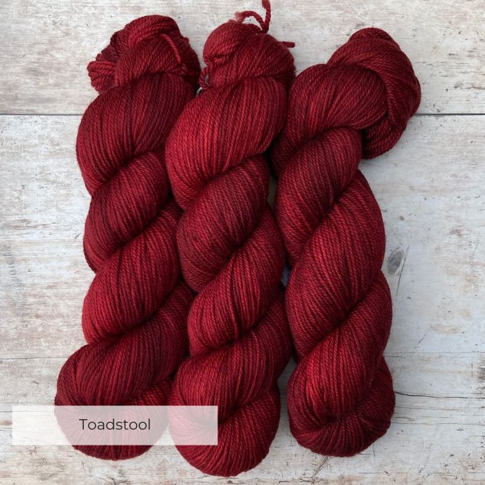 Three skeins of Plump in a rich, deep red