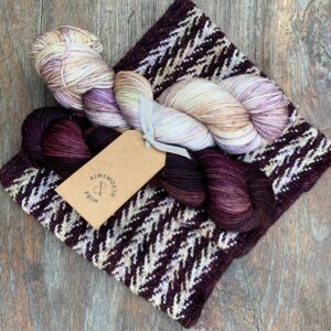 Slipped Stitch knitted cowl with maroon and lavender skeins of yarn