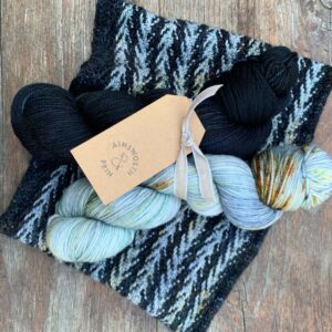 Slipped Stitch knitted cowl with blue/black and sea blue skeins of yarn