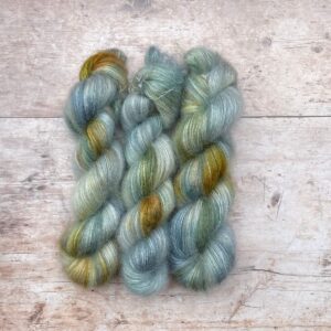 Three skeins of Mohair Lace in watery shades of blue and green with splashes of golden yellow