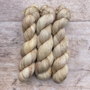 Three skeins of Merino Silk in shades of cream and buff