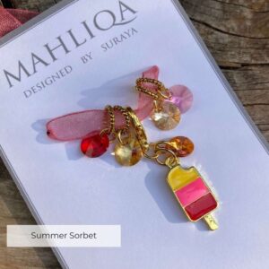 A removable marker in the shape of an ice lolly with four crystal markers in red, pink, bronze and gold