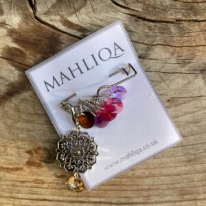 A removable marker with five crystal markers in lilacs, plums and pinks