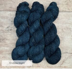 Three skeins of Flax yarn in a deep dark blue