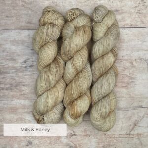 Three skeins of merino and linen in buttercream, coffee and gold