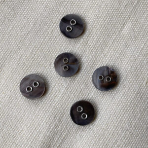 Five grey coloured shell buttons with metal holes 11mm