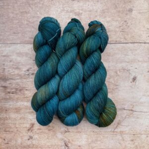 Three Skeins of Plump Sock Yarn in shades of blue, teal and gold