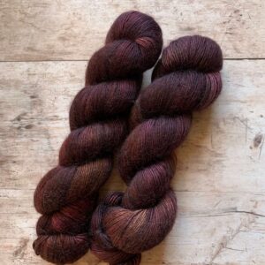 Two skeins of fluffy Merino Mohair in deep plum, brown and bronze