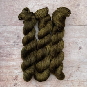 Three skeins of Floof in a dark Khaki