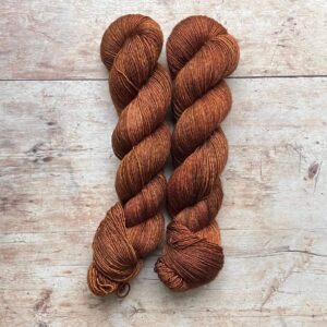 Two skeins of Merino Silk in a rich ginger with pink overtones