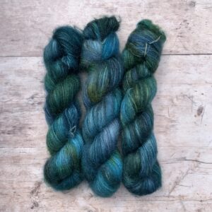 Three skeins of Mohair Silk Lace in dark blues, emeralds and lime