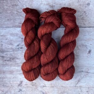 Three skeins of Mohair sock in a rich rusty red