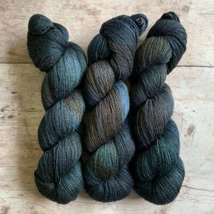 Three skeins of Merino Silk in very dark inky blue, green and rust